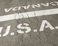Parallel Paths image - Pavement at Canada-U.S. Border (sephia tone)