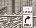 Parallel Paths image - Turn sign at Canada-U.S. Border (sephia tone)